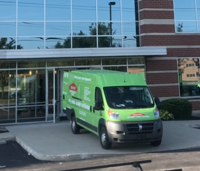 SERVPRO vehicle parked out front of structure.