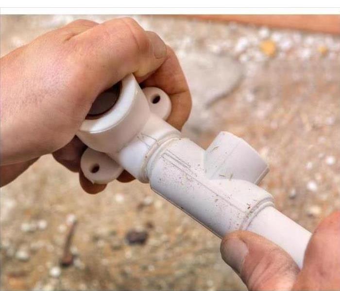 Hand holding Polybutylene pipes