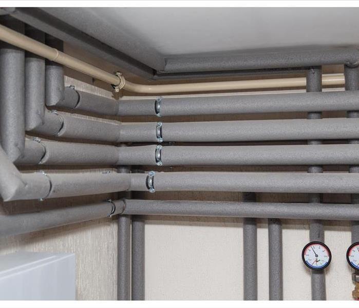 The pipelines in the insulation and pressure gauges flow and return pipes in the boiler room of a private household